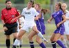 Bentonville’s Tayler Estrada, left, heads the ball Friday in front of Fayetteville’s Taylor Hightower, right, and Taylor Ward during the first half of the Lady Tigers’ game against the Lady Bulldogs in Bentonville. 