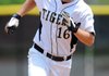 Bentonville’s Ryan Harralston rounds second base on a RBI triple Saturday during the second inning of the Tigers’ game against Rockhurst, Mo., in Bentonville. 