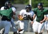 Tearris Wallace, a Bentonville running back, breaks through the line on a carry Thursday during the Tigers’ spring practice at Tiger Stadium in Bentonville. 