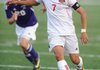 Nelson Landaverde, Springdale High, sends the ball up the field as Fayetteville junior Jamey Morrison defends April 27 during the first half of play at Jarrell Williams Bulldog Stadium in Springdale.