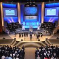 Ben Mayes, center, president of Shiloh Christian School, welcomes graduates Thursday to the graduati...