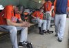 Hunter Wood, left, Rogers Heritage’s ace pitcher, reflects on his team’s loss to Bryant on Friday in the Class 7A State Baseball Final at Baum Stadium in Fayetteville. 