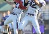 Chadd Holmes, Fayetteville senior receiver, right, reaches to catch a pass near the goal line as junior Ramsey Jones defends Friday during the Bulldogs’ annual spring Purple-White game at Harmon Field