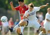 Springdale’s Martin Castenada, left, and Little Rock Catholic’s John Lewis battle for the ball Friday during the second half of the Class 7A Boys State Soccer Championship at Razorback Field in Fayetteville. 