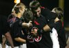 White Hall outfielder Nathan Lee hugs teammate Jacob Holland (29) after beating Watson Chapel 4-2 in 10 innings Friday to win the Class 5A state championship at Baum Stadium in Fayetteville.