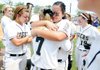 Macey Brake, right, a Bentonville catcher, embraces pitcher Kali Piha following the Tigers’ 8-4 loss to Bryant on Saturday during the Class 7A State Softball Championship game at Bogle Park in Fayetteville.