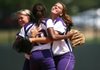 Junction City players Olivia Petty (left), Shania Hoof (center), and Leann Cannon embrace after the Lady Dragons beat Buffalo Island Central 3-0 Saturday for the Class 2A state championship. 