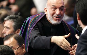 Afghan President Hamid Karzai greets people as he arrives at the meeting Monday on Afghanistan during the NATO summit in Chicago. 