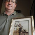 Kelly Meroney holds a photo of his father, Air Force Capt. Virgil Kersh Meroney III, who was killed ...