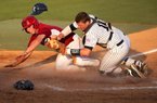 Arkansas' Tim Carver is out at home in a collision with Rice catcher Craig Manuel during the sixth inning of an NCAA college baseball tournament regional game Saturday, June 2, 2012, in Houston.