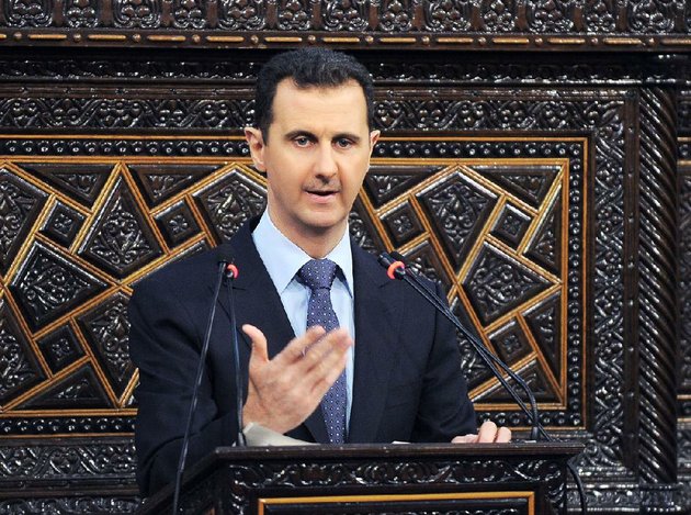 in-this-photo-released-by-the-syrian-official-news-agency-sana-shows-syrian-president-bashar-assad-as-he-delivers-a-speech-at-the-parliament-in-damascus-syria-sunday-june-3-2012-the-presidents-first-comments-on-the-massacre-expressed-horror-over-the-deaths-of-more-than-100-people-nearly-half-of-them-children-un-investigators-say-there-are-strong-suspicions-that-pro-government-gunmen-carried-out-the-killings-but-assad-denied-that-ap-photosana