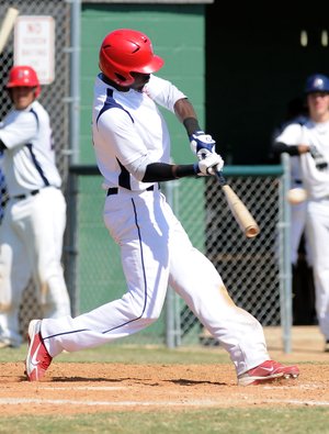 D’Vone McClure hits a two-run home run Friday at Tyson Sports Complex in Springdale. McClure was offered a scholarship by the University of Arkansas and was drafted by the Cleveland Indians. 