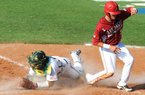 Arkansas third baseman Matt Reynolds (right) scores past Baylor’s Josh Ludy in the sixth inning of the Bears’ 8-1 NCAA super regional victory Saturday in Waco, Texas. Reynolds had singled to left with one out, then scored on a double by Dominic Ficociello.
