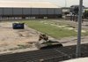 Contractors start tearing away artificial turf at Gates Stadium at Heritage High School in Rogers on Tuesday. Six inches of densely packed soil must be removed from the field in preparation for new turf. 
