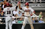 Arkansas' Brian Anderson high-fives Jake Wise after scoring against South Carolina on a single by Matt Vinson in the fourth inning of an NCAA College World Series baseball game in Omaha, Neb., Monday, June 18, 2012. (AP Photo/Ted Kirk)