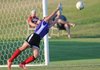 Emma Gartner of Springdale Har-Ber blocks a kick Tuesday during a shootout to determine the winner of the Arkansas High School Coaches Association All Star Game at Razorback Field in Fayetteville. The game ended in a 4-3 shootout with the West winning, 2-1.