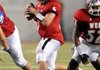 Dallas Hardison, West All-Star quarterback, of Bentonville looks for an open receiver against the East in the third quarter of the All-Star game Thursday at Razorback Stadium in Fayetteville. 