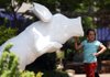 Arkansas Democrat-Gazette/WILLIAM MOORE
Olivia Goodwin-Harrison, 10, of Fayetteville looks over one of the fiberglass pigs to be used in the PIGShibition community art project Saturday, June 23, 2012 at the farmers market in downtown Fayetteville.  The pigs, which were designed by Fayetteville sculptor Michael Davis Gutiérrez, will be painted by local artists and displayed around town from early July until October 24.  The project was sponsored by the Ozark Literacy Council, and the Fayetteville Advertising and Promotion Commission,