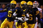 November 25, 2011 - Olive Branch senior WR D'Arthur Cowan (7) returns a first quarter punt for a TD against the Jaguars of Madison Central High School in the third round of MHSSAA Class 6A state playoffs.  Heading downfield with Cowan are OBHS senior LB Nick Johnson (5) and junior lineman Nick Hall (66).      (Stan Carroll/The Commercial Appeal)