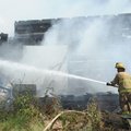 Capt. Willie Watts fights a fire that destroyed a structure Thursday at 11199 W. Arkansas 156 near W...