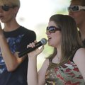 Sarah Fair, 16, of Rogers, sings Thursday with her brothers in the Fair Family during the CreekFest ...