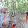 Carissa Hanson wipes away sweat after her shift with the chain saw.