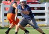 Peyton Squires, right, of Springdale Har-Ber High School cuts across Colton Noeltner of Rogers Heritage High School on Monday during a 7-on-7 scrimmage at Springdale Har-Ber High School.