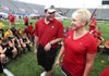 Chase Miller (left) and Michelle Uekman, mother of former Arkansas Razorbacks football player Garrett Uekman. talk to players at the Garrett Uekman 7-on-7 Football Camp on Friday at War Memorial Stadium in Little Rock. Miller, a former high school teammate, helped pitch the idea for the Garrett Uekman Memorial tournament. 