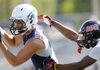 Nick Byrne, left, a Springdale Har-Ber receiver, hauls in a pass in front of Bastrop, La., defensive back William Field during Friday’s game in the Southwest Elite 7-on-7 Showcase in Springdale. 