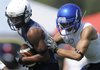 Springdale’s Deandre Murry, left, turns up field after a catch Friday during the Bulldogs’ game against Stillwater, Okla., during the Southwest Elite 7-on-7 Showcase in Springdale