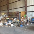 Prairie Grove residents Melissa Sanders, right, and Lacey Marler unload trash Friday at the Boston M...