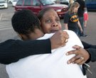 Shamecca Davis hugs her son Isaiah Bow, who was an eye witness to the shooting, outside Gateway High