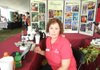 Sherrie Smith, the University of Arkansas Division of Agriculture’s plant diagnostic instructor for family and consumer science in Phillips County, mans a booth at the 2011 Rice Expo. 