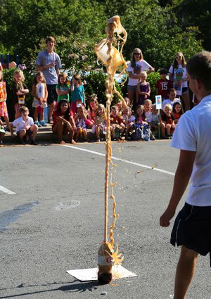 Arkansas Democrat-Gazette/RICK MCFARLAND --7/20/12-- A soda pop erupts in a chemical reaction to the amusement of students during the closing ceremony for the Vacation Bible School at Trinity United Methodist Church in Little Rock Friday.