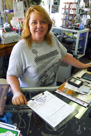 Arkansas Democrat-Gazette/BILL BOWDEN

7/20/12

Pamela Montoya, owner of Memory Lane Collectibles in Huntsville, has wet/dry petitions on the counter for people to sign.