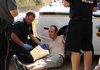 A Pea Ridge Firefighter examines Jeremy Watkins after Watkins led Benton County Sheriff's Office Deputies and Pea Ridge police officers on an approximately two-hour manhunt.