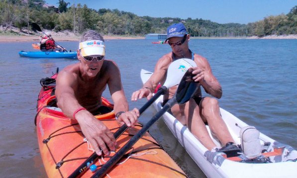 Jeff Spencer of Bentonville, left, gets advice from Herbert in adjusting his paddle.