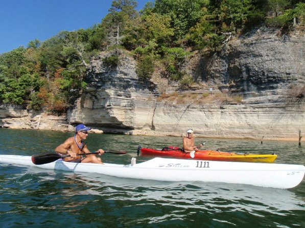 Herbert and Jeff Spencer of Bentonville talk paddling technique during a group trip around Bear Island. About 50 kayakers circumnavigated the island.