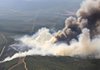 Smoke billows from a wildfire Wednesday near Ola in Yell County. A mandatory evacuation of a rural area between Ola and Birta was under way Wednesday evening, county officials said. 