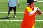 Dowell Loggains (back), who was a walk-on quarterback for the Arkansas Razorbacks in 2000, is making a name for himself in the NFL as the Tennessee Titans’ quarterbacks coach. “Dowell’s reputation has grown as one of the bright young coaches in the NFL,” ESPN analyst Chris Mortensen said. “He’s held in high regard throughout the league.” 