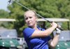 Abbie Parker hits an iron on the Pinnacle Country Club driving range on Friday. Parker, a junior at Rogers High School, is one of the top returning players.