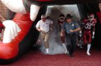 Capt. Lance King runs onto the field with former Arkansas football coach Bobby Petrino prior to a game in 2008. Arkansas State Police set new policies on Friday for troopers serving at sporting events. 