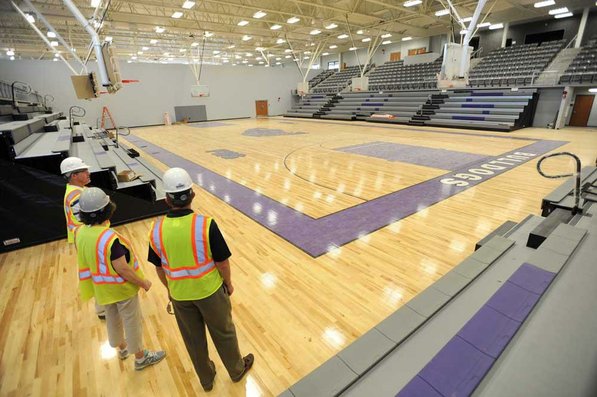 
                               
                                  Photo by Andy Shupe&mdash;
                               
                           
                           Officials walk through the gymnasium Thursday, Aug. 3, 2012, during a tour of the additions to the Fayetteville High School building.