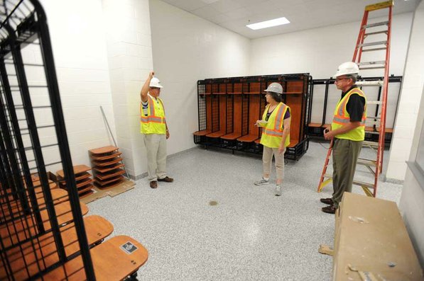 
                               
                                  Photo by Andy Shupe&mdash;
                               
                           
                           Officials walk through the locker rooms Thursday, Aug. 3, 2012, during a tour of the additions to the Fayetteville High School building.