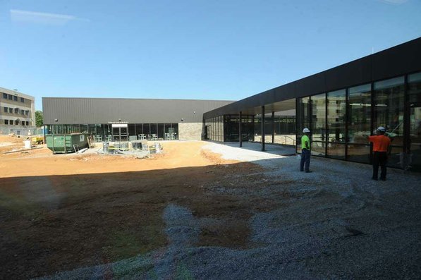 
                               
                                  Photo by Andy Shupe&mdash;
                               
                           
                           Officials walk through the courtyard Thursday, Aug. 3, 2012, during a tour of the additions to the Fayetteville High School building.