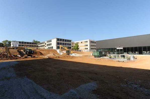 
                               
                                  Photo by Andy Shupe&mdash;
                               
                           
                           Officials walk through the courtyard Thursday, Aug. 3, 2012, during a tour of the additions to the Fayetteville High School building.