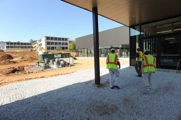 
                               
                                  Photo by Andy Shupe&mdash;
                               
                           
                           Officials walk through the courtyard Thursday, Aug. 3, 2012, during a tour of the additions to the Fayetteville High School building.