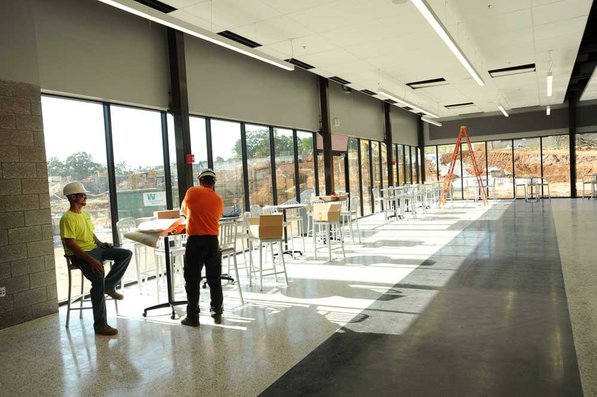 
                               
                                  Photo by Andy Shupe&mdash;
                               
                           
                           Officials walk through the cafeteria Thursday, Aug. 3, 2012, during a tour of the additions to the Fayetteville High School building.