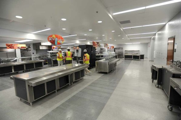 
                               
                                  Photo by Andy Shupe&mdash;
                               
                           
                           Officials walk through the cafeteria Thursday, Aug. 3, 2012, during a tour of the additions to the Fayetteville High School building.