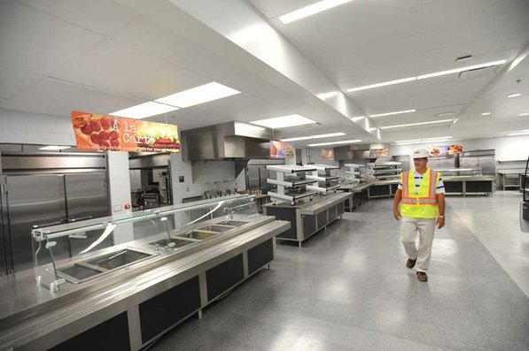 
                               
                                  Photo by Andy Shupe&mdash;
                               
                           
                           Officials walk through the cafeteria Thursday, Aug. 3, 2012, during a tour of the additions to the Fayetteville High School building.
